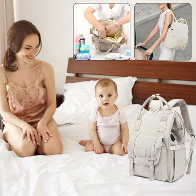 Sac à langer sac à dos maman, bébé lit sourient